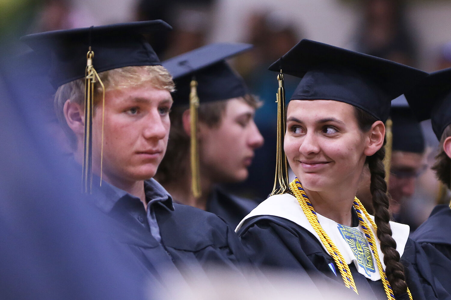 Laurel Rozema looks into the bleachers to her family as commencement speaker Dick Edgcomb